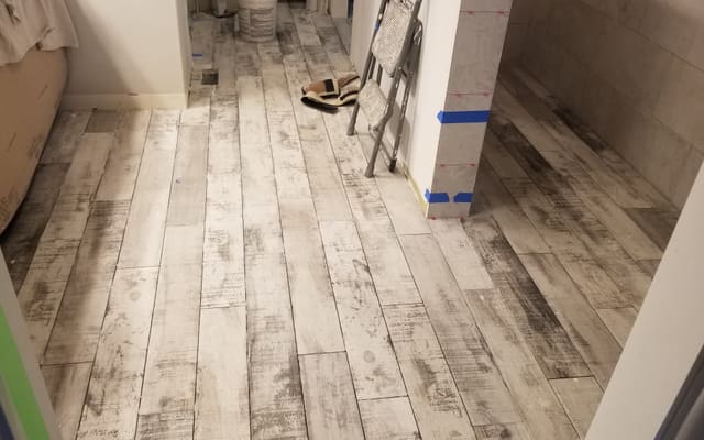 Light distressed wood-look plank flooring installed down a hallway