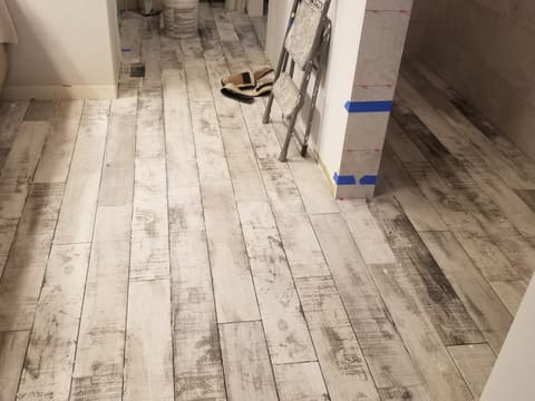 Light distressed wood-look plank flooring installed down a hallway