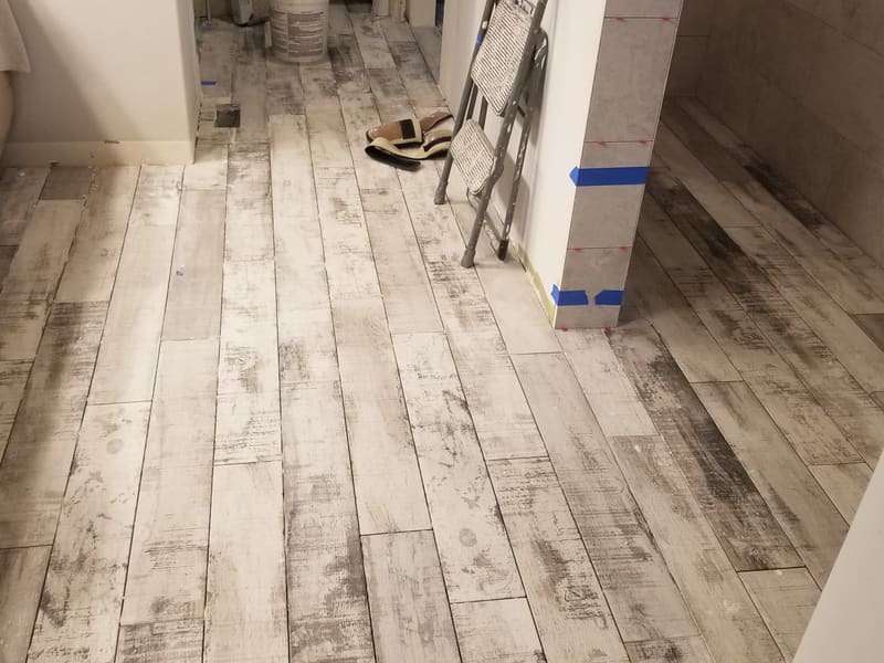 Light distressed wood-look plank flooring installed down a hallway