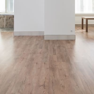 Light natural oak-look plank flooring installed in an open room