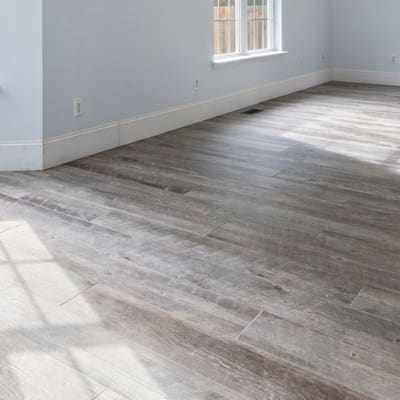 Grey driftwood-look plank flooring installed in a living room