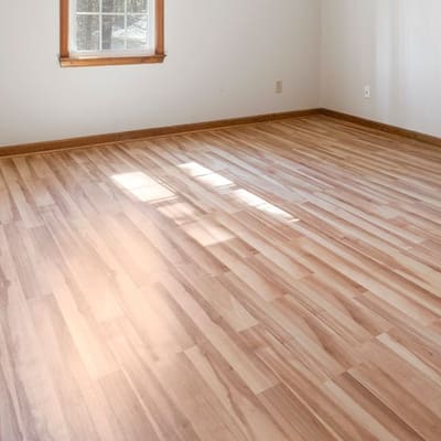 Warm honey-tone plank flooring installed in a bedroom