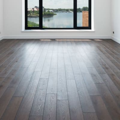 Dark walnut-look plank flooring installed in a bright room
