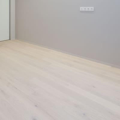 Pale whitewashed-look plank flooring installed in a modern room